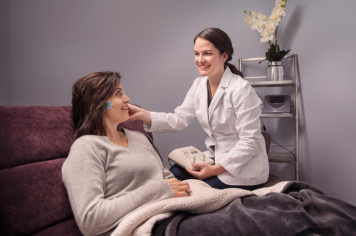 Woman-sitting-comfortably-in-dental-chair-with-hygienist.jpg