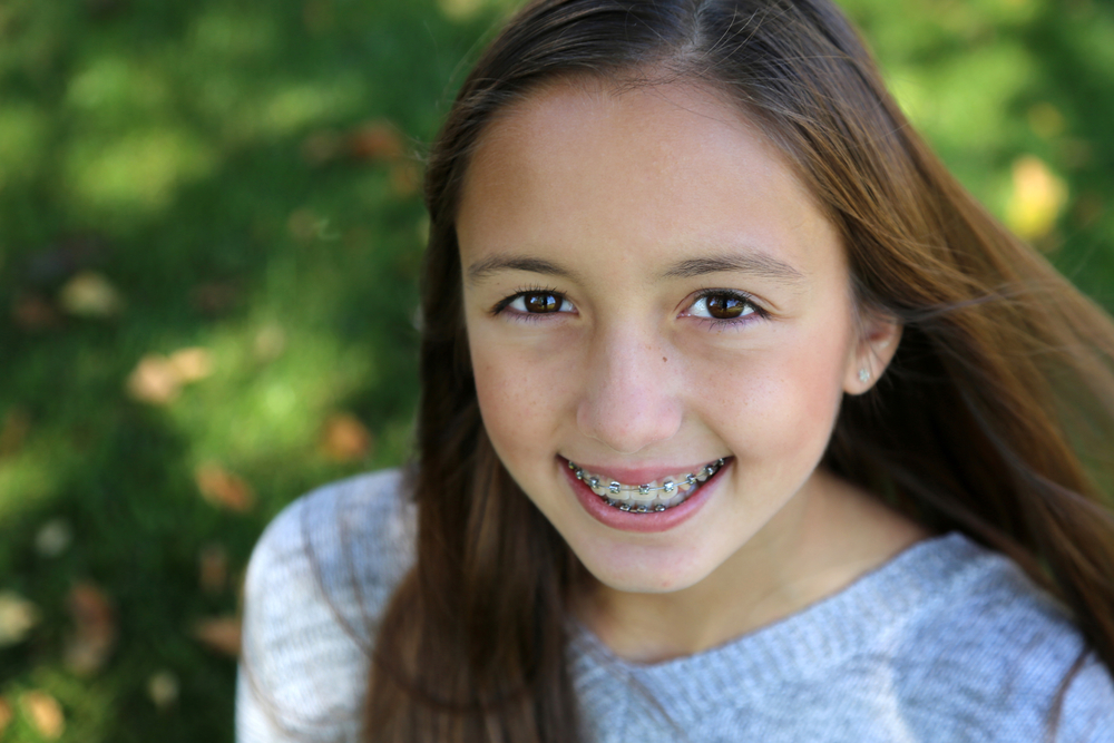 Young girl with braces smiling